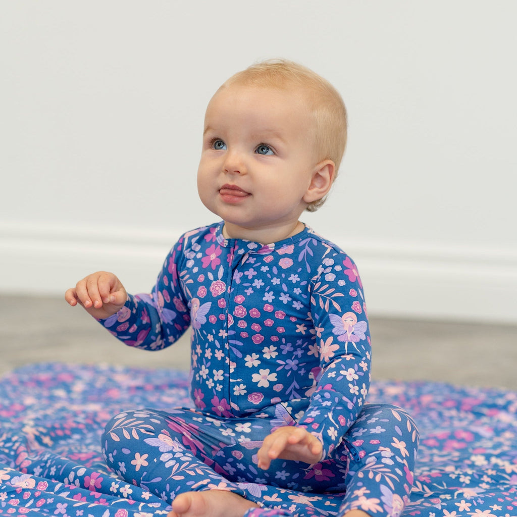 Blue floral long-sleeve romper on child, full-length legs and round neckline