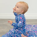Blue floral long-sleeve romper with full-length legs and round neckline