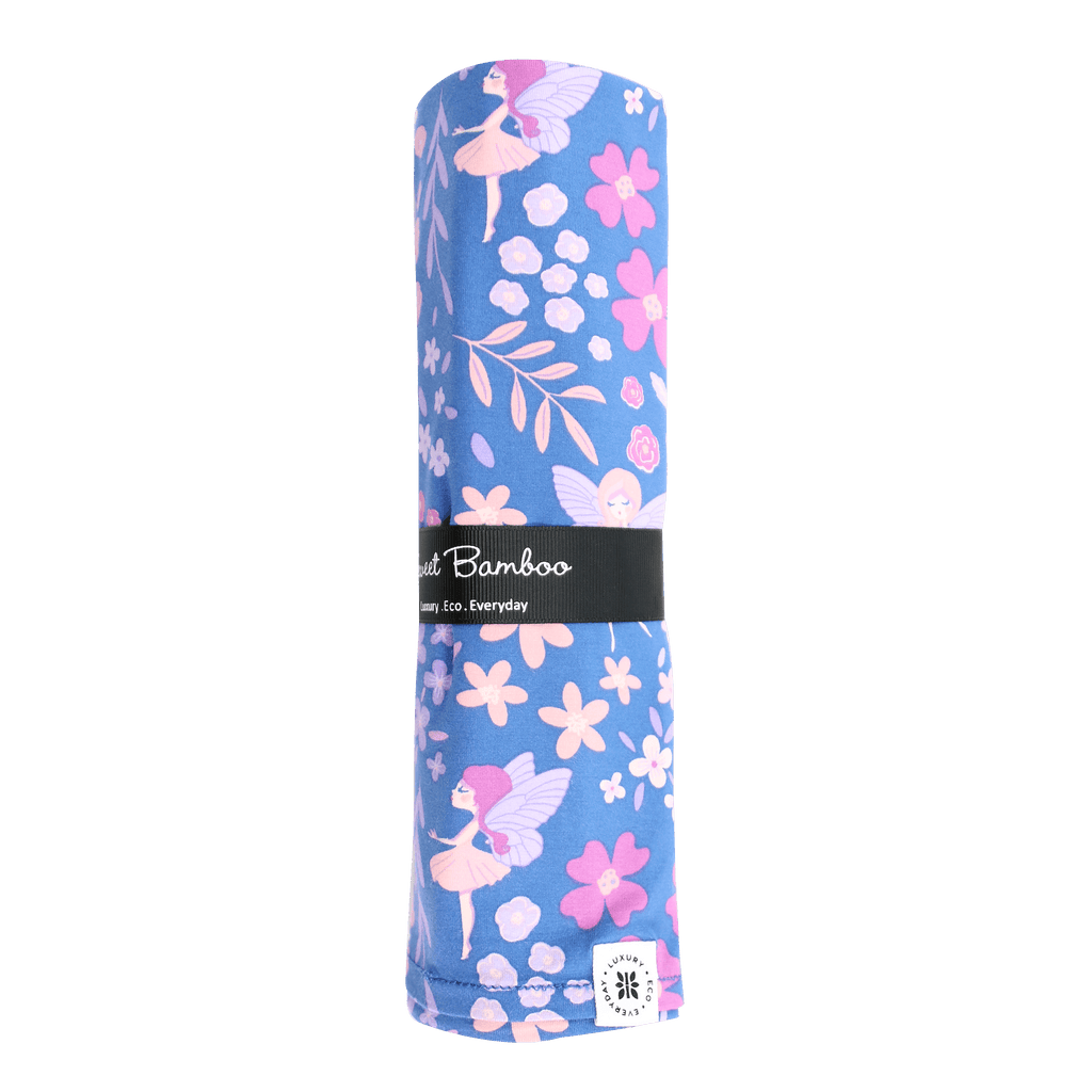 Swaddle blanket roll in purple with pink floral and bird fairy pattern, with fabric label