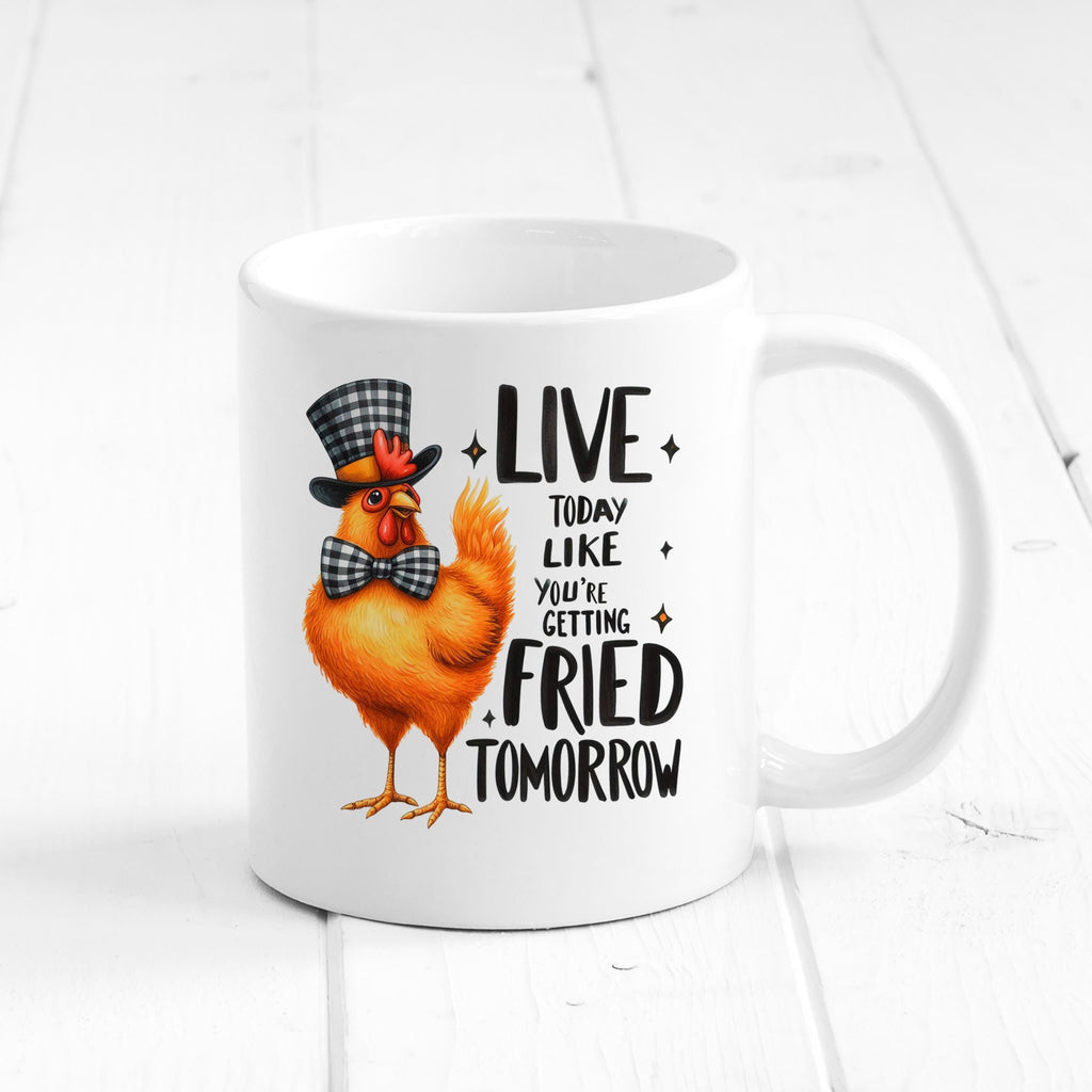 White ceramic mug with orange cartoon chicken and LIVE…FRIED TOMORROW slogan