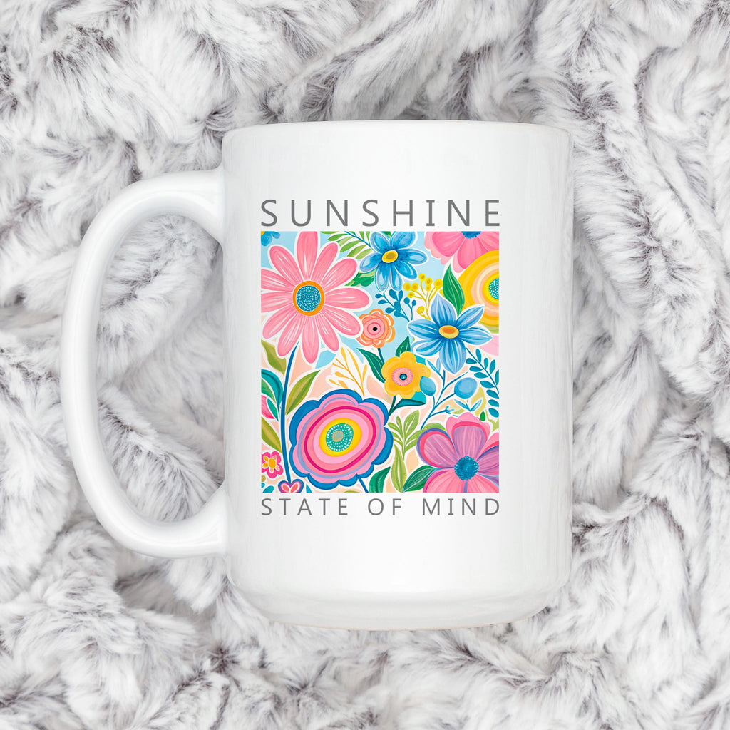 White ceramic coffee mug with colorful floral print and “Sunshine State of Mind”.