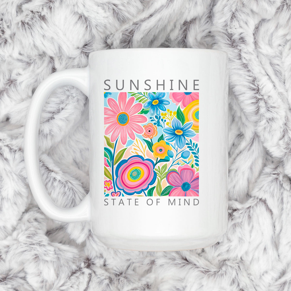 White ceramic coffee mug with colorful floral print and “Sunshine State of Mind”.