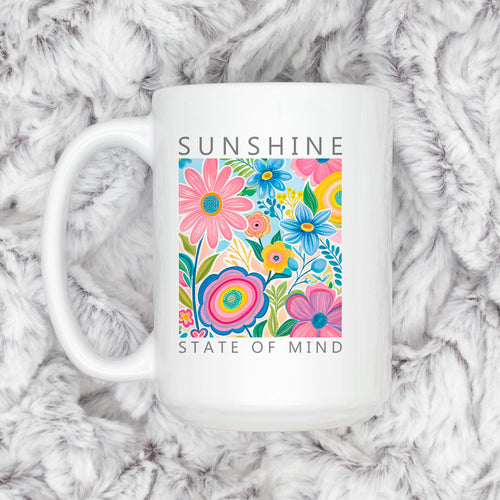 White ceramic coffee mug with colorful floral print and “Sunshine State of Mind”.