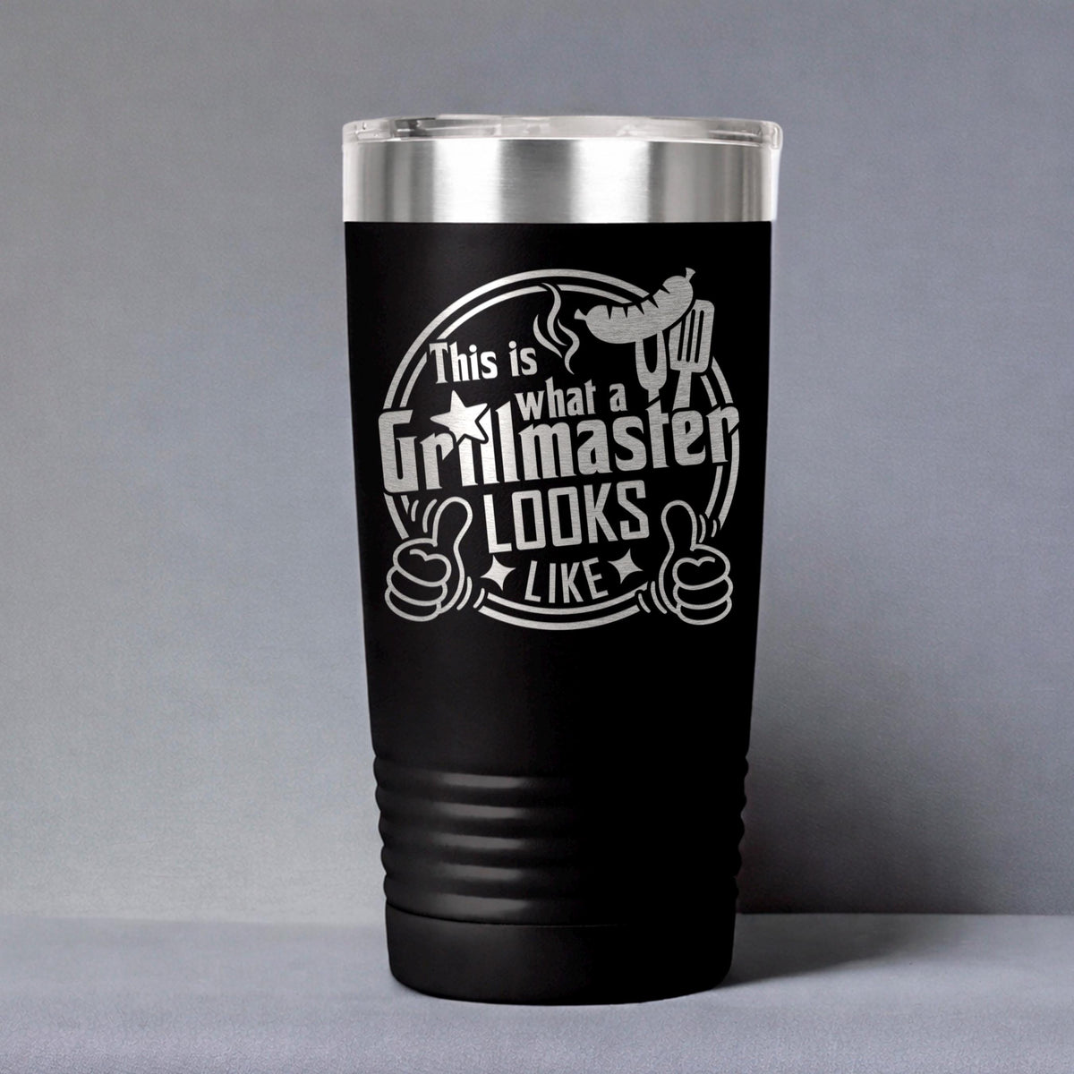 Black insulated stainless steel tumbler on gray background with Grillmaster logo
