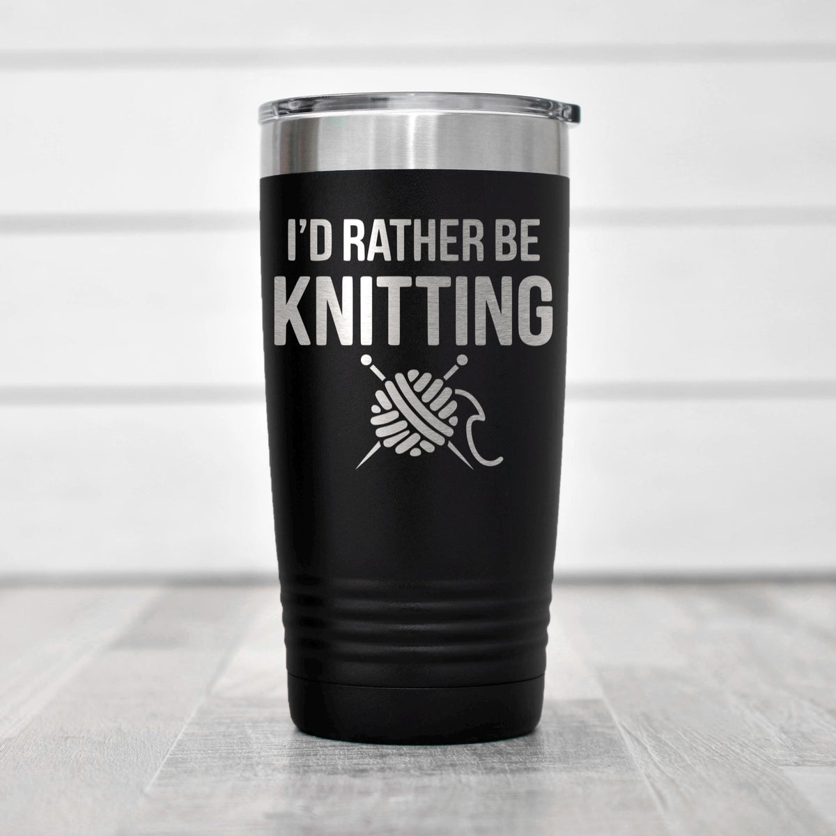 Double-wall stainless steel tumbler with black body and knit slogan design