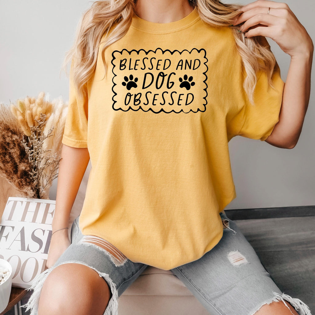 Mustard yellow short-sleeve T-shirt with “Blessed and Dog Obsessed” paw print graphic