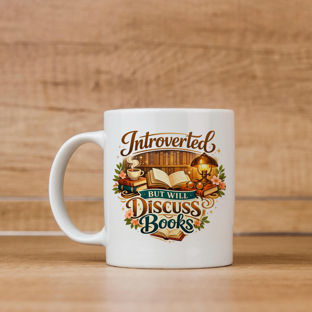 White ceramic coffee mug with colorful "Introverted, but will discuss books" design
