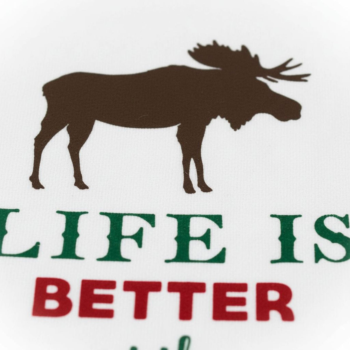 White towel close-up with brown moose silhouette and green/red 'Life is Better' lettering