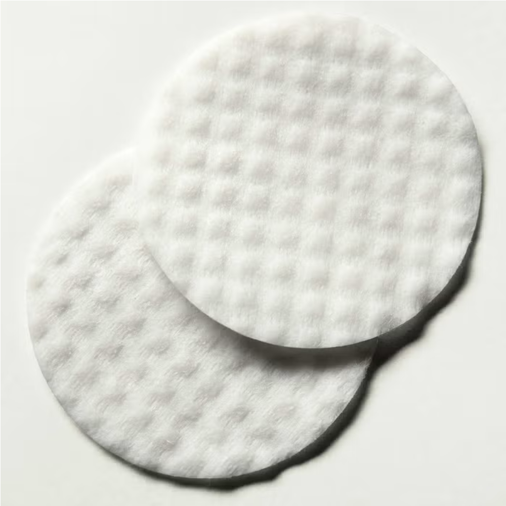 Round white facial pad with dark edge, skin smoothing pad