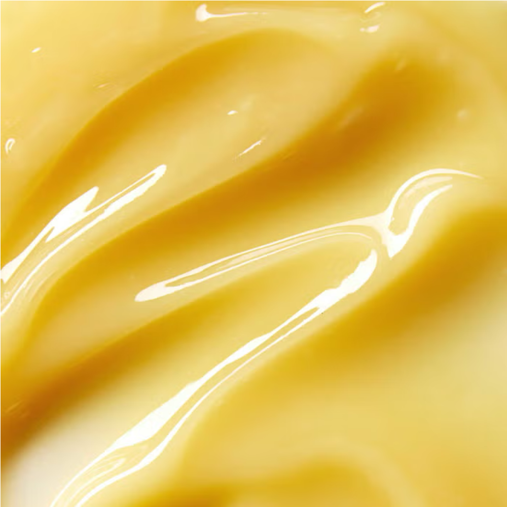 Golden cleansing balm texture with smooth, glossy swirl