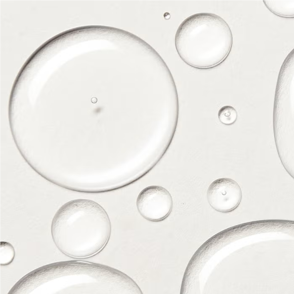 Skincare oil droplets on a smooth surface