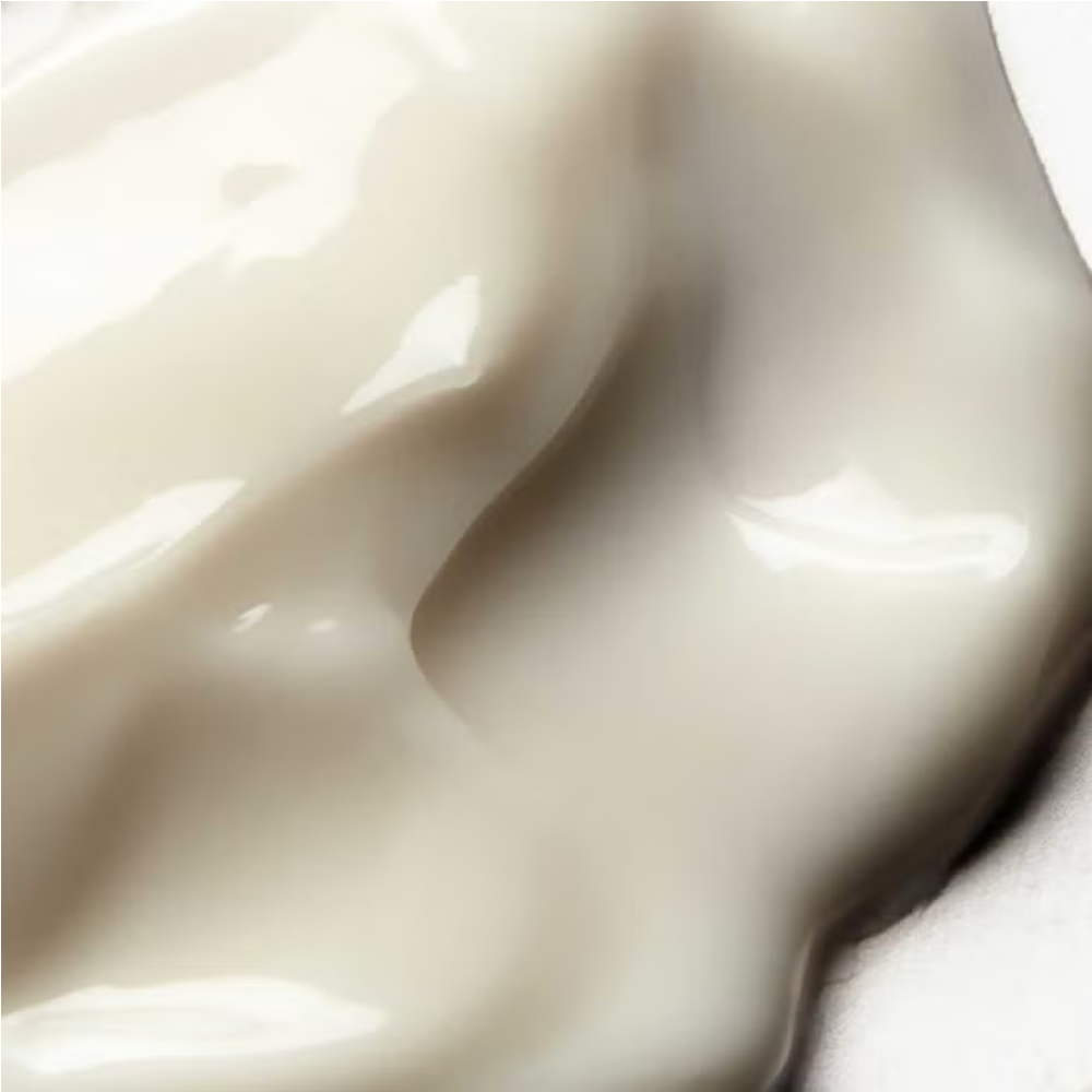 Creamy balm texture on skin, pale ivory and glossy