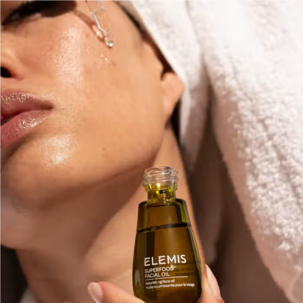 Facial oil bottle with dropper, oil applied to face with a single droplet