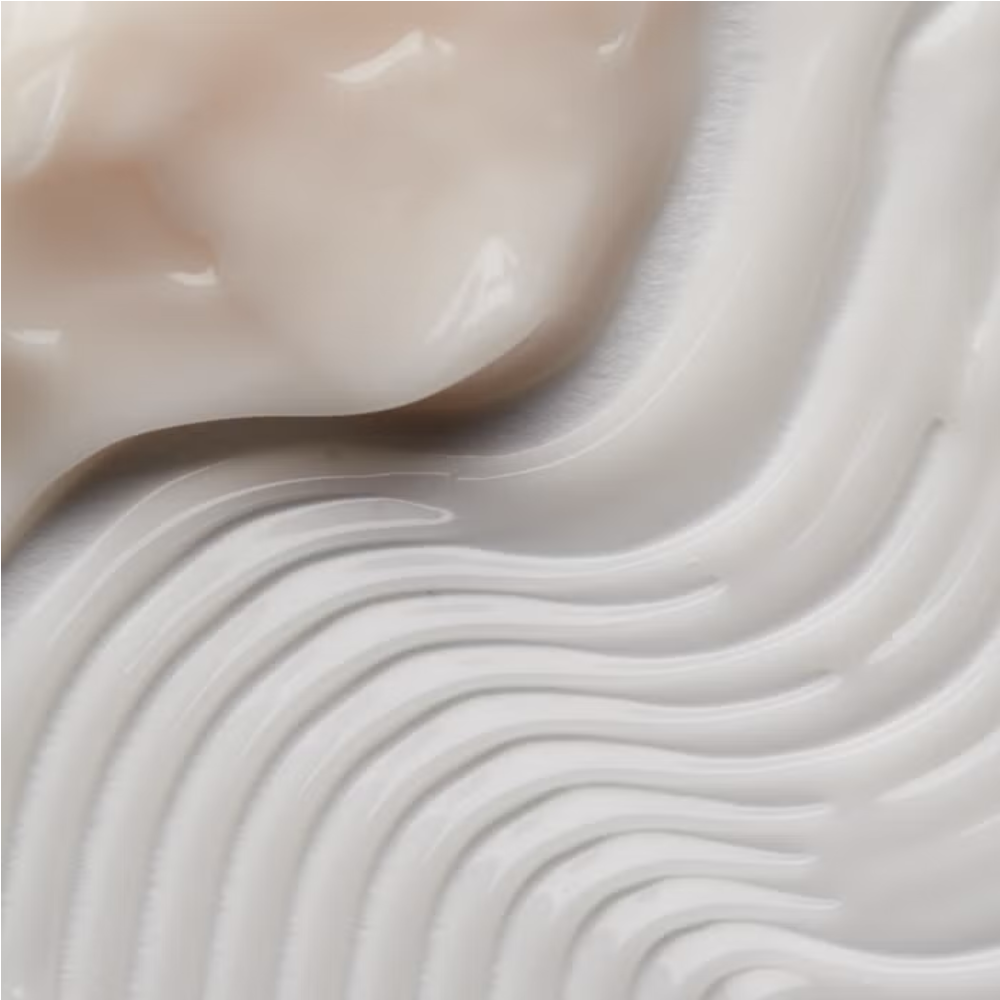 Facial cream texture with smooth swirls, pale pink sheen