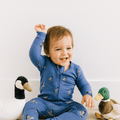 Elmer Fudd convertible romper in blue with animal print and snap front