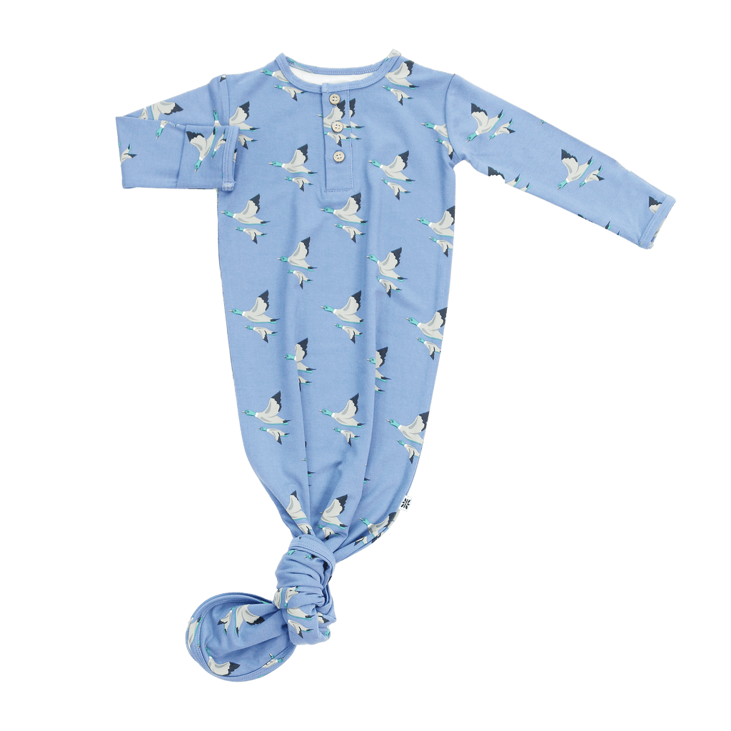 Blue knotted baby gown with long sleeves, henley buttons, and bird pattern