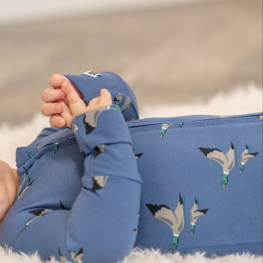 Blue bird-print zip-front footie sleeve and zipper guard detail