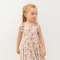 Girls racerback dress in light pink with allover snack print, ruffled sleeves