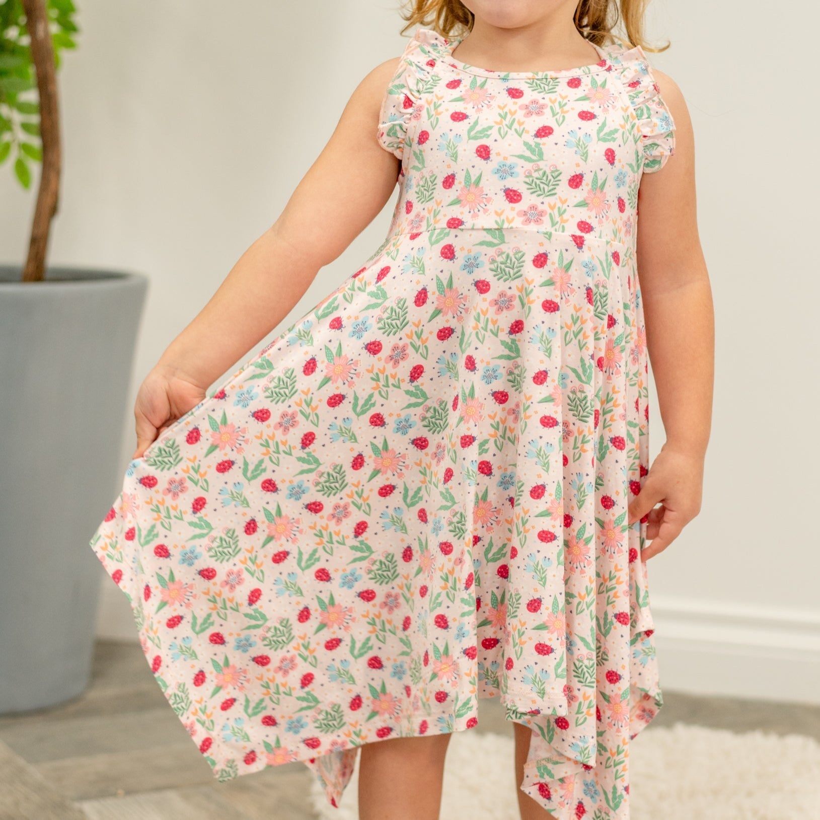 Girls’ racerback dress with playful ladybug and garden print; tiered, swingy hem