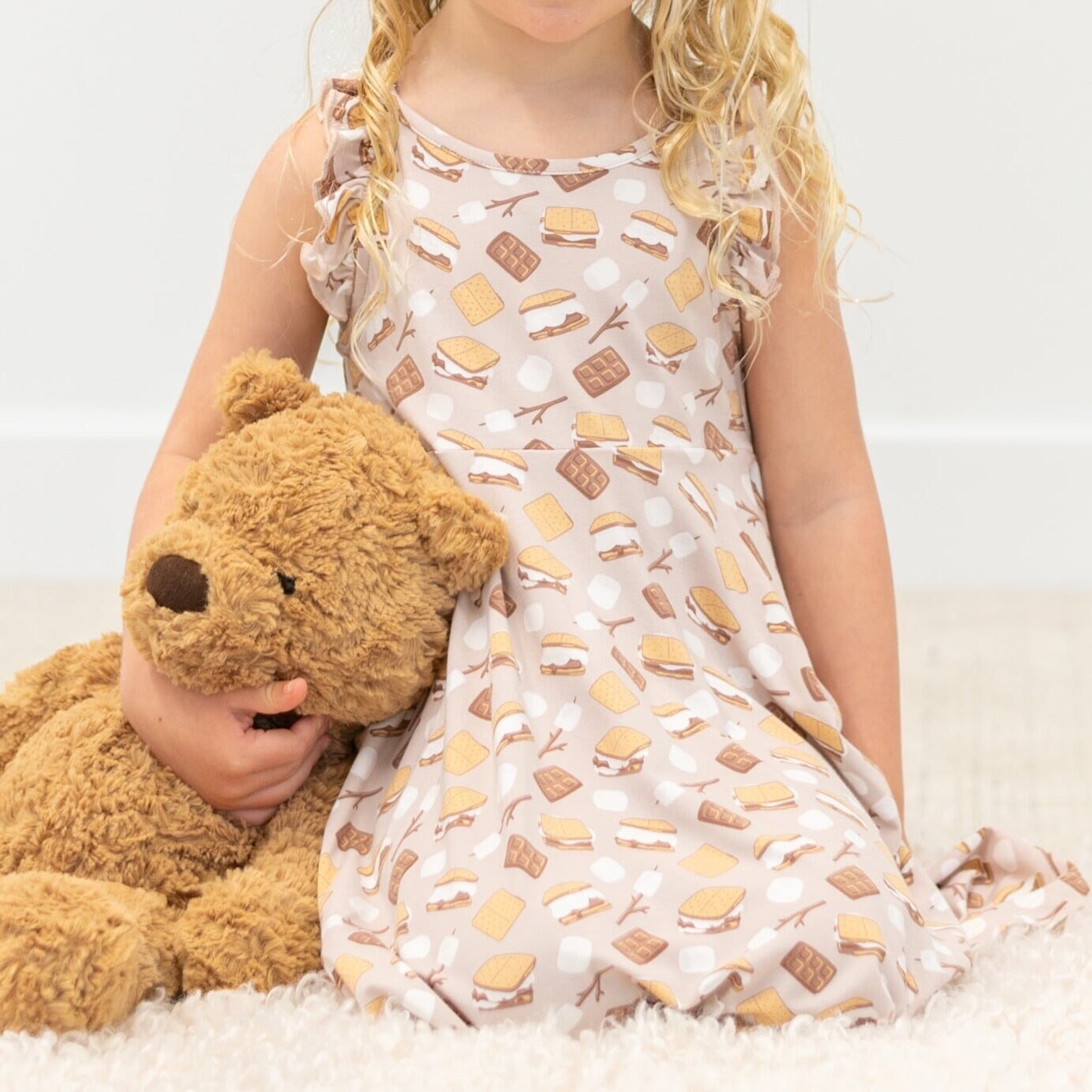 Girls racerback dress, light background with snack print, close-up of bodice and straps