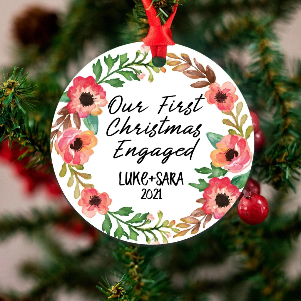 Personalized round engagement Christmas ornament with floral wreath and names Luke+Sara, 2021