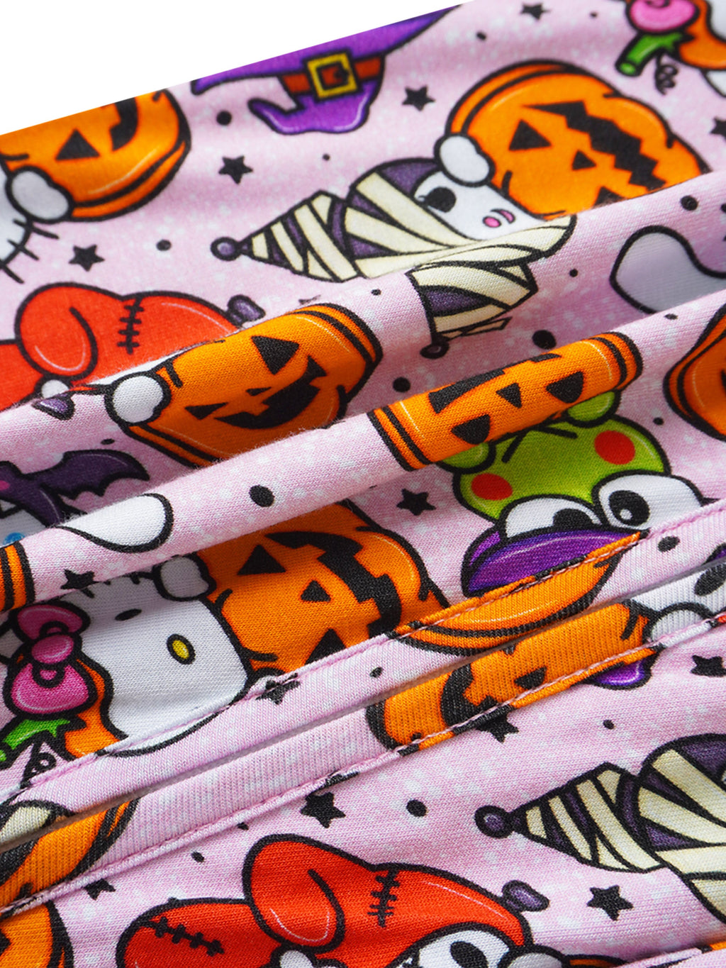 Baby romper fabric close-up, light lavender with Halloween pumpkin and character motifs