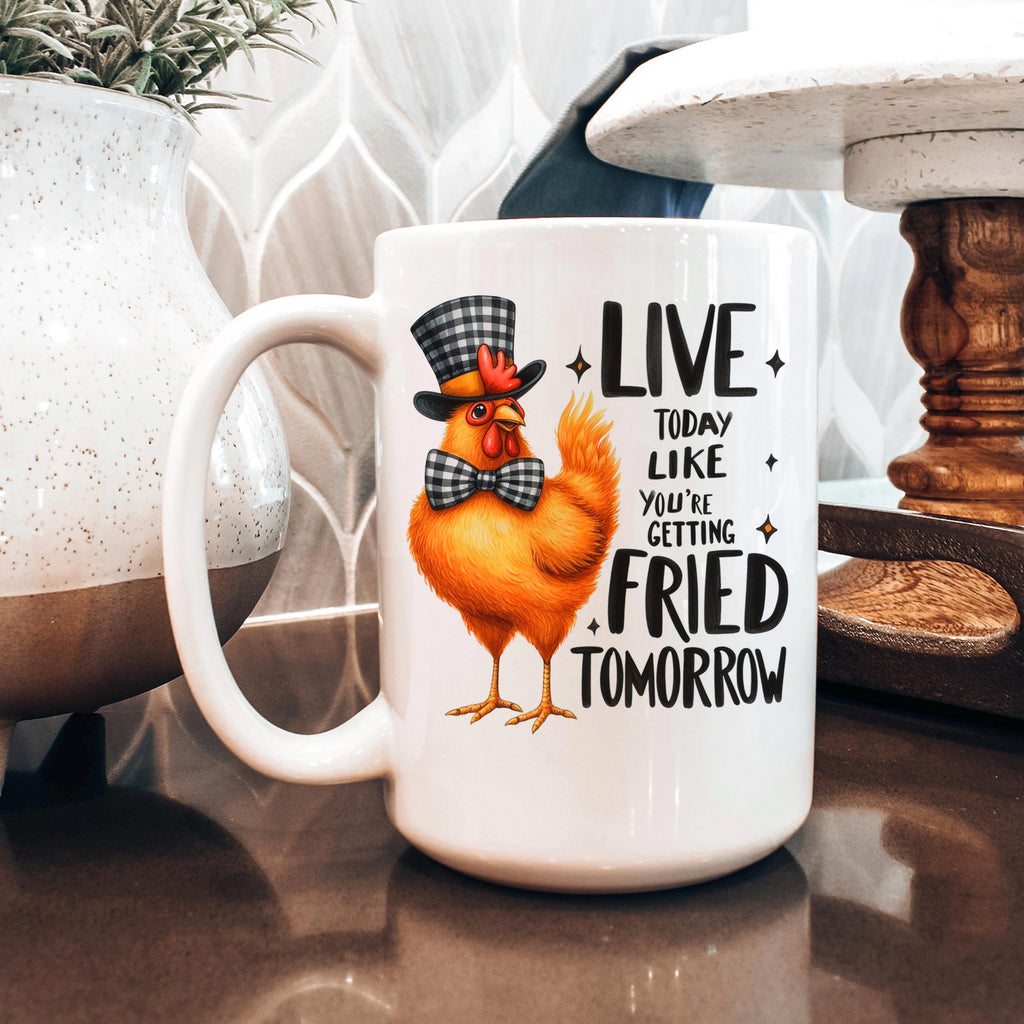 White ceramic mug with orange cartoon chicken illustration and LIVE…FRIED TOMORROW slogan