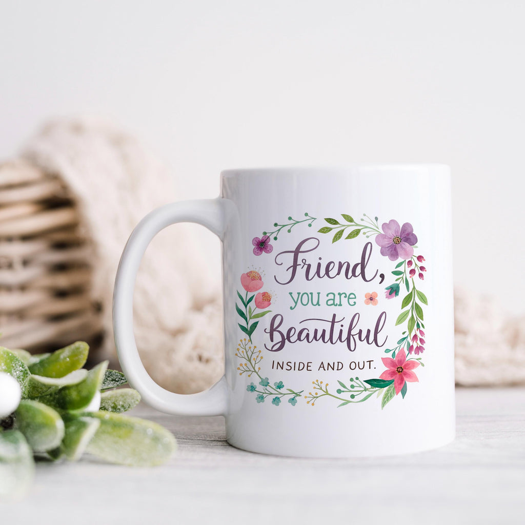 White coffee mug with colorful floral wreath and “Friend, you are Beautiful”