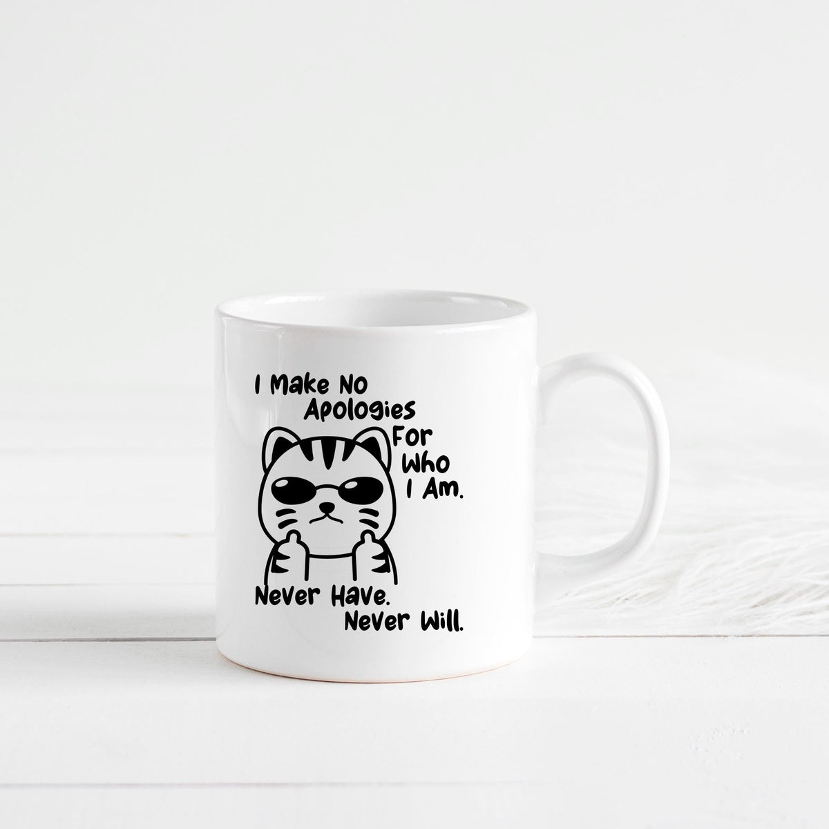 White ceramic coffee mug featuring a black cat illustration and the quote “Never Have. Never Will.”