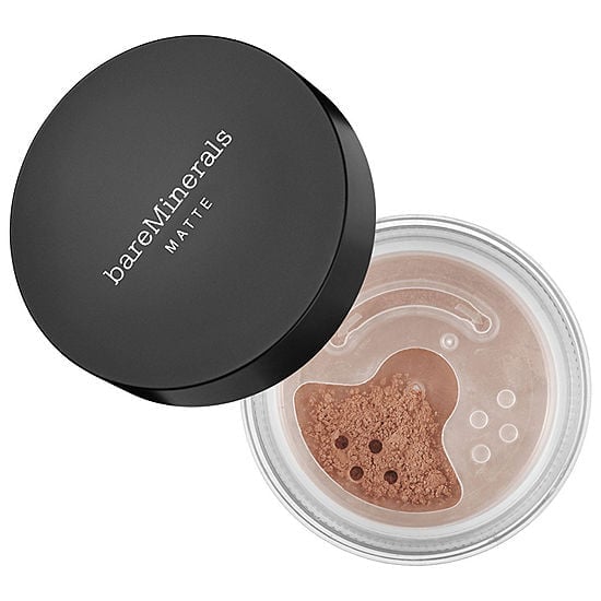 Medium tan matte foundation compact with powder in clear jar and black lid
