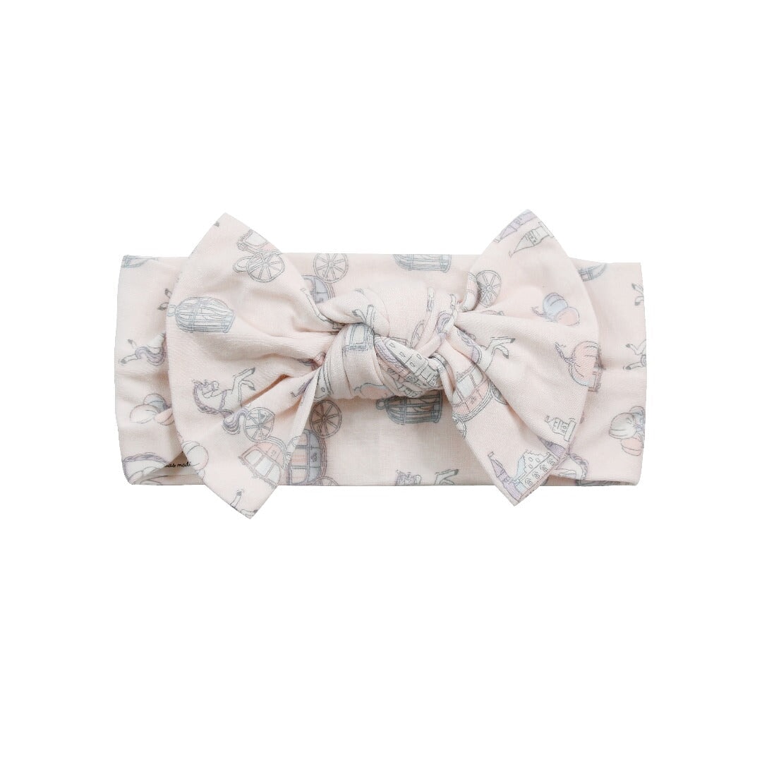 Knotted bow headband for baby girl, light printed fabric with pastel icons.