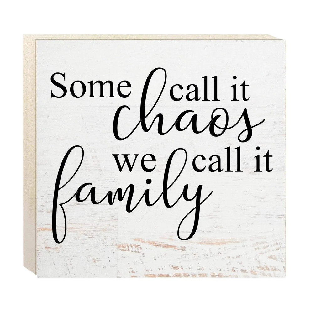 White wooden wall sign with black cursive quote: Some call it chaos, we call it family.