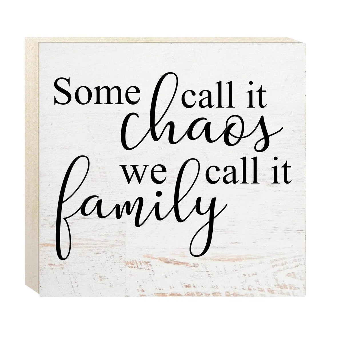 White wooden wall sign with black cursive quote: Some call it chaos, we call it family.