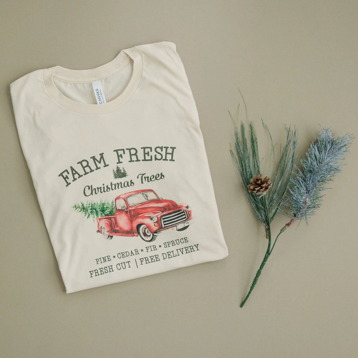 Cream T-shirt featuring Farm Fresh Christmas Trees red truck and pine delivery text