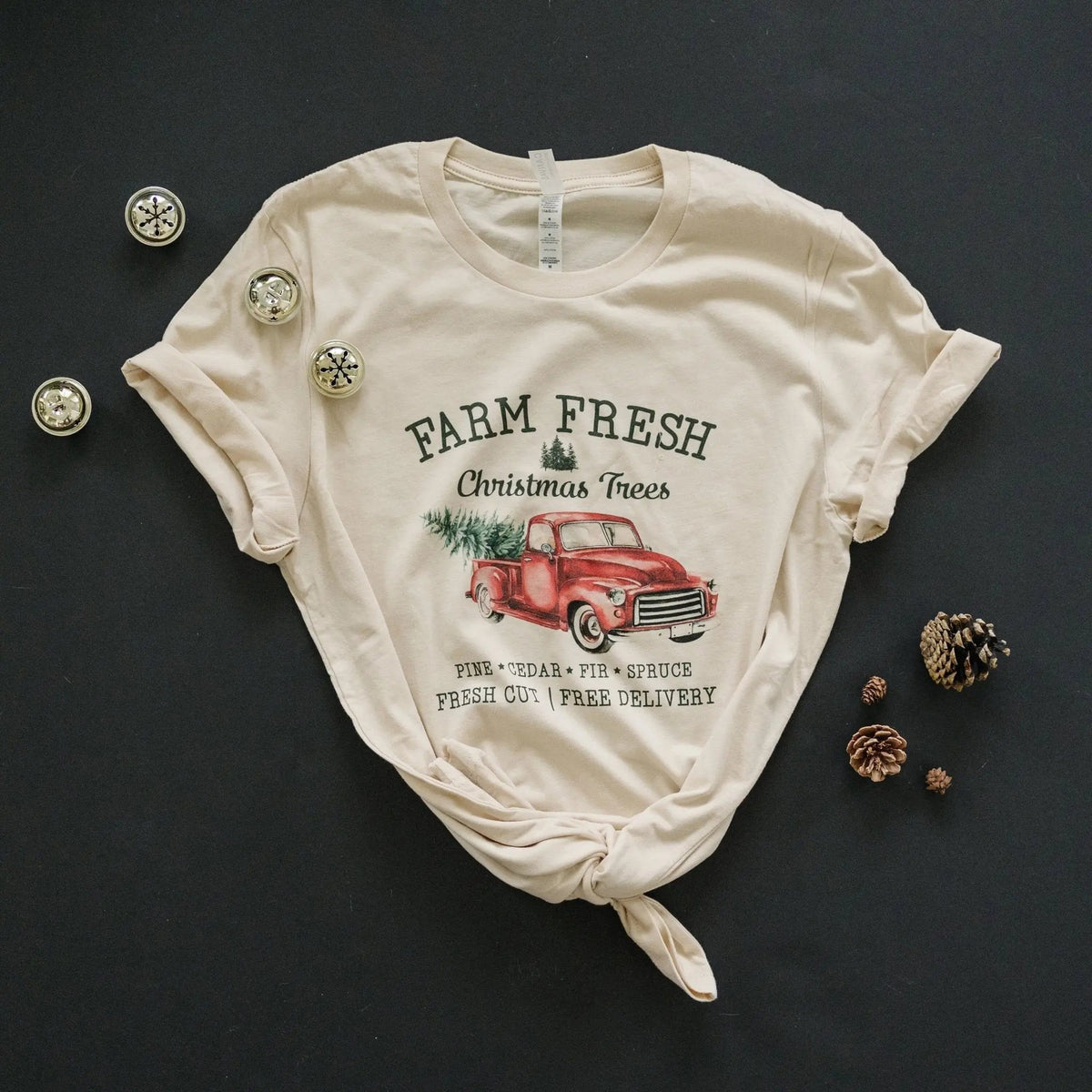 Cream T-shirt folded flat with Farm Fresh Christmas Trees red pickup truck front graphic