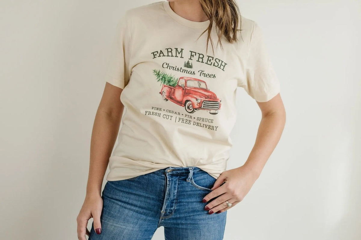 Cream T-shirt on model with Farm Fresh Christmas Trees red pickup truck front print