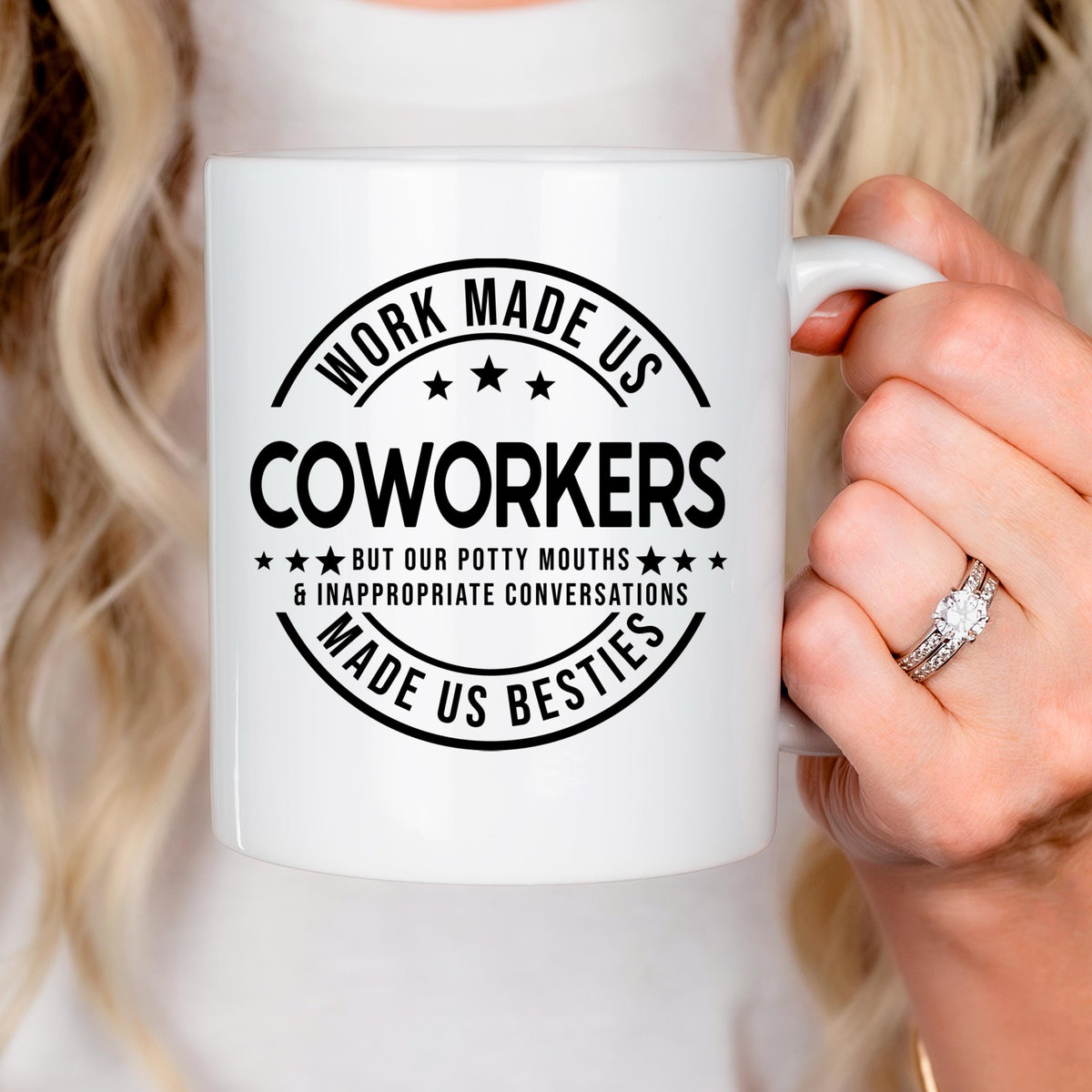 White ceramic mug with black coworker humor text graphic on the front