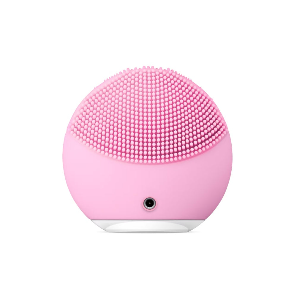 FOREO facial cleansing massager in pearl pink, showing charging port