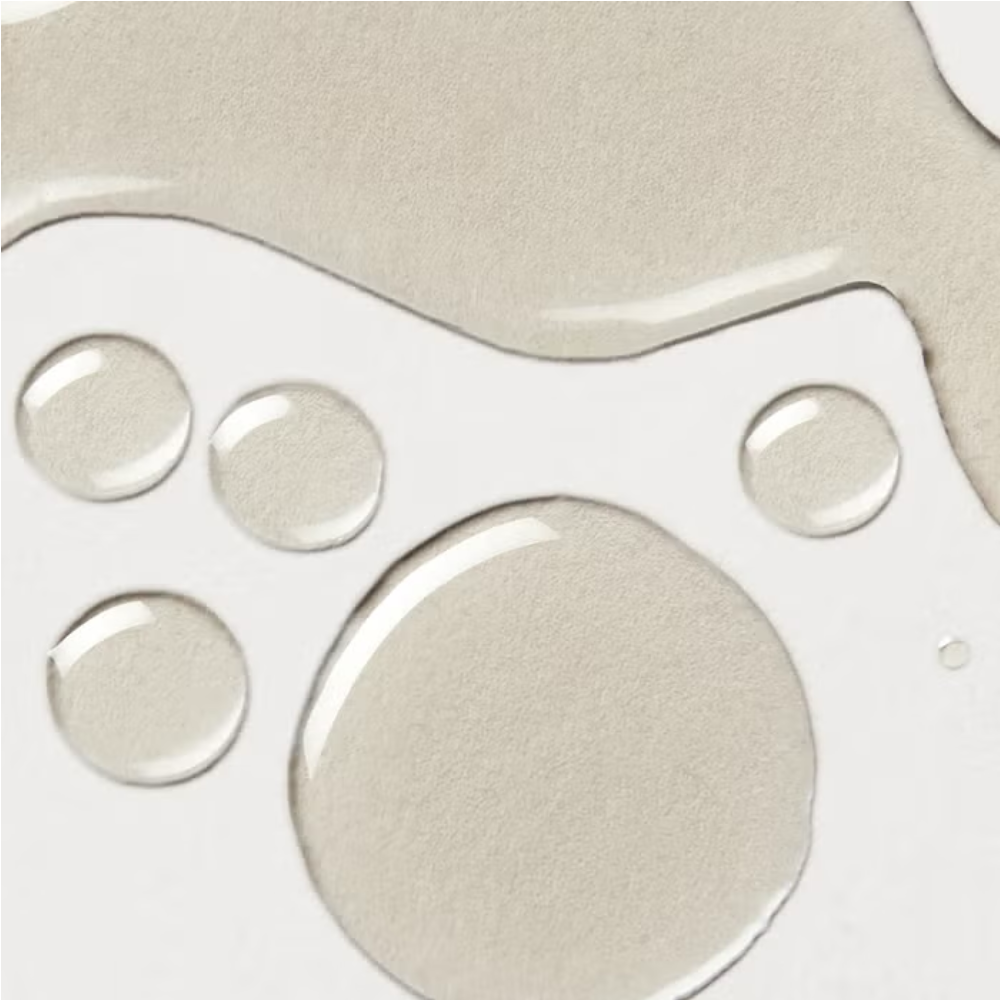 Body oil label close-up with circular embossed dots and large oval shape