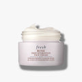 Face cream jar in pale pink with label and lid showing cream swirl