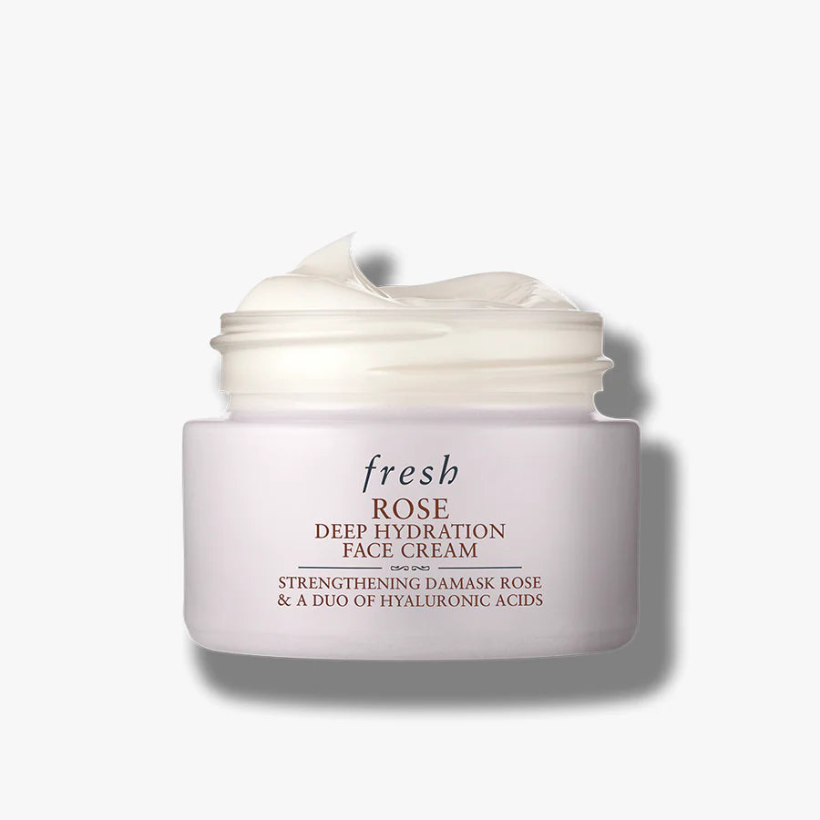 Face cream jar in pale pink with label and lid showing cream swirl