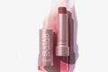 Fresh sugar lip balm set with mauve cap and lip balm tube, one showing balm swirl.
