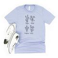 Light blue unisex T-shirt with botanical herb names and leaf illustration, crew neck
