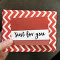Gift wrap with red-and-white chevron border and 'Just for you' label