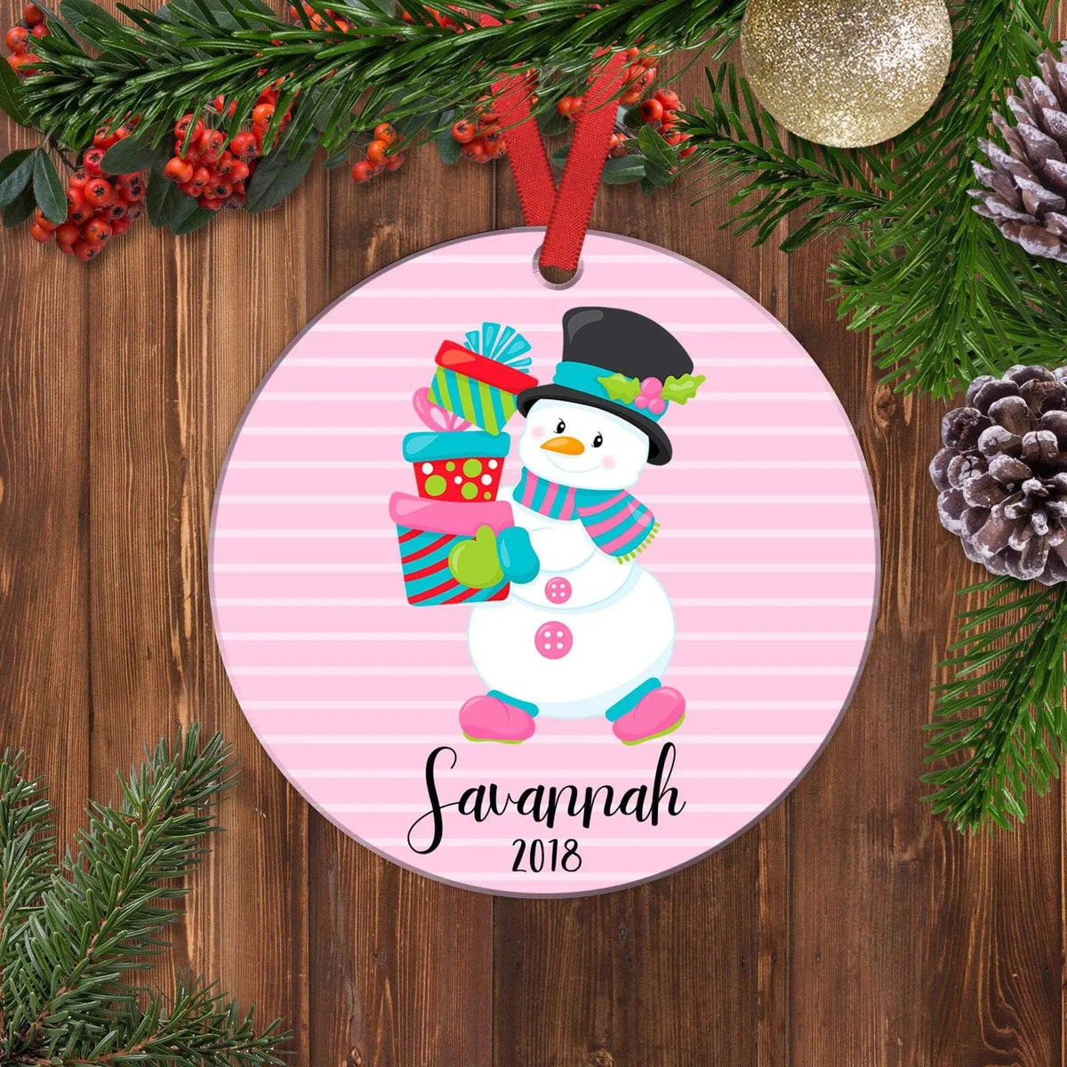 Pink snowman Christmas ornament with hanging red loop and 'Savannah 2018' text