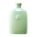 Oribe Cleansing Crème bottle, light green with brand emblem on front