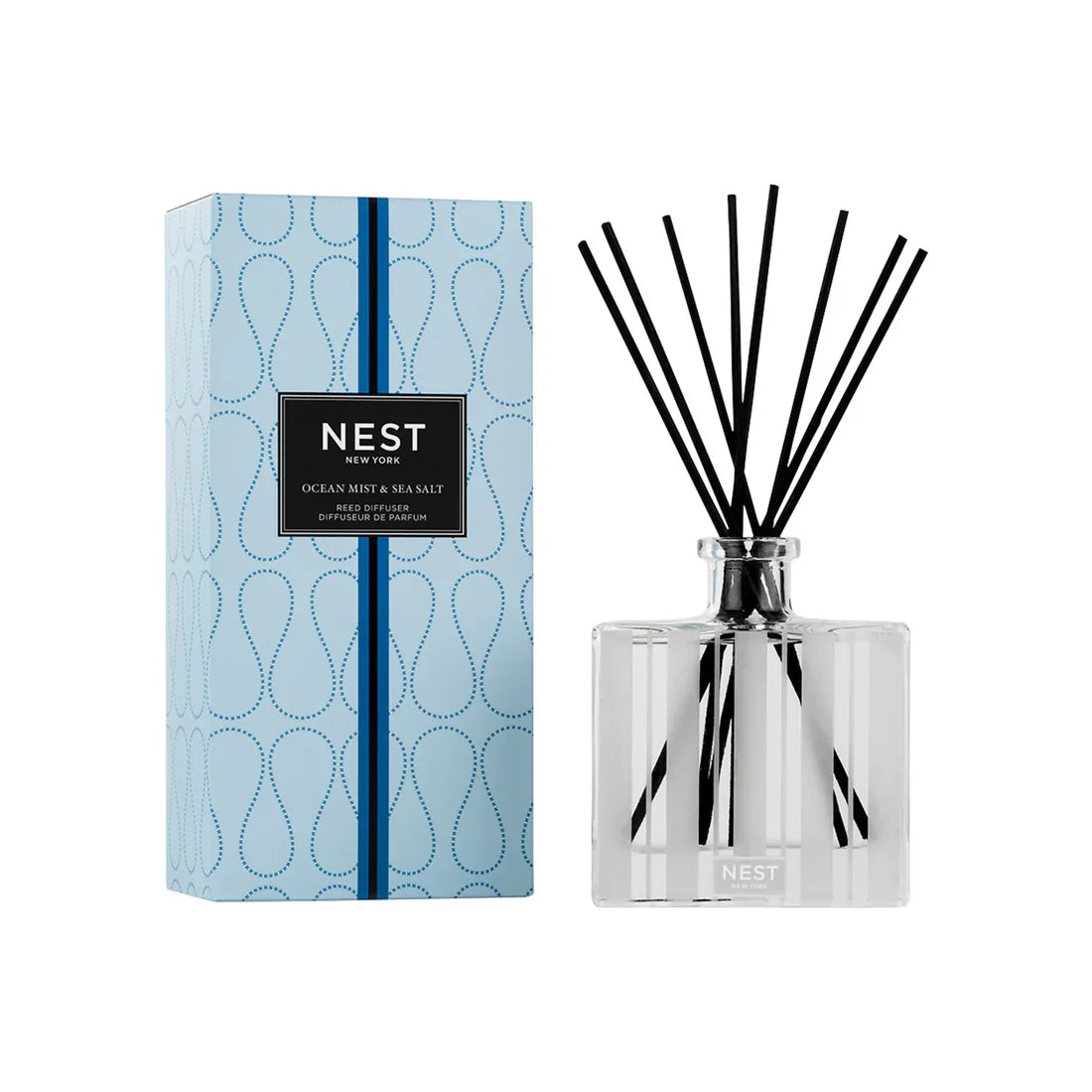 Reed diffuser set with ocean-blue box, clear glass bottle, and black reeds