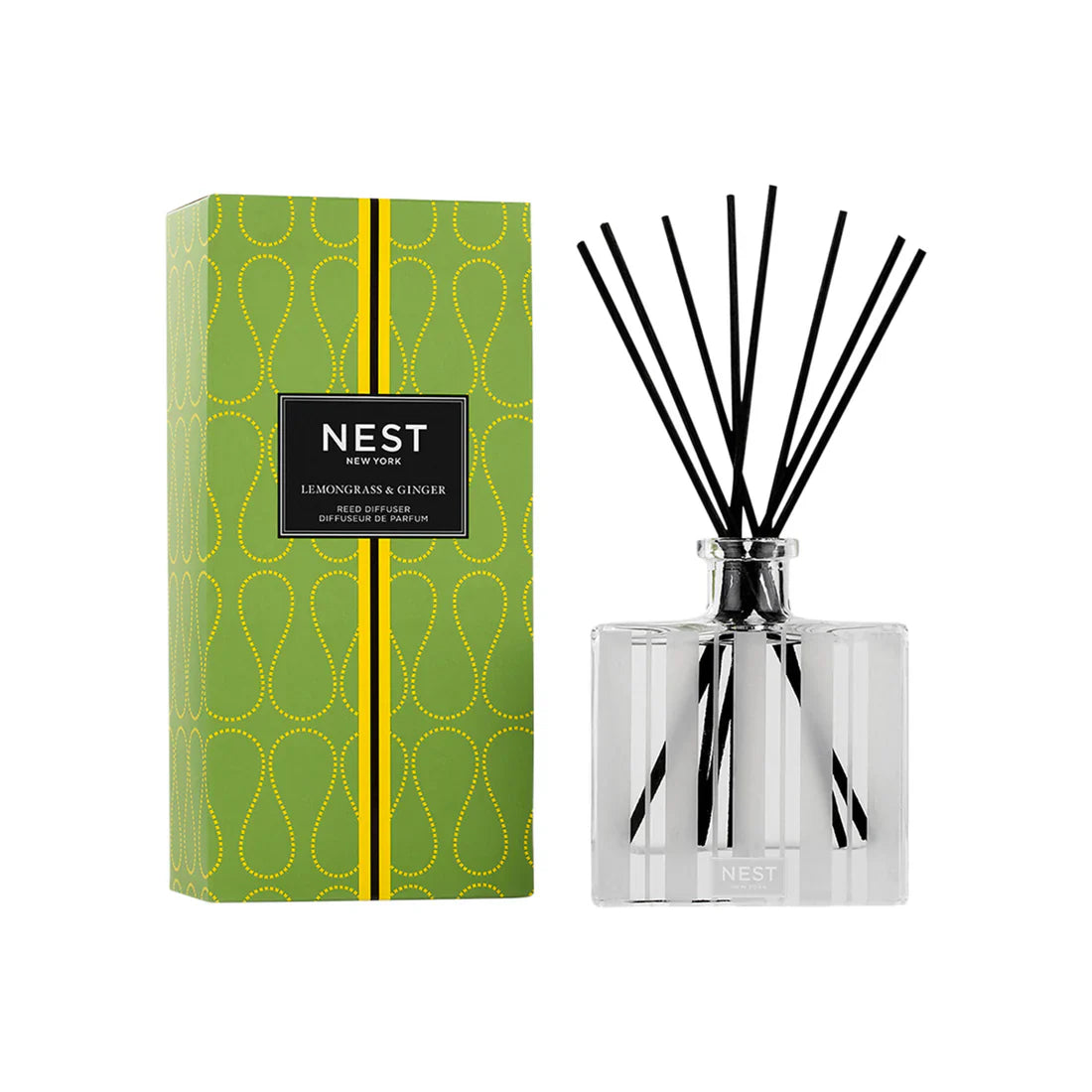 Glass reed diffuser bottle with black reeds; green patterned box and label