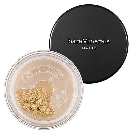 Warm tan matte foundation compact with beige powder in clear jar and black lid