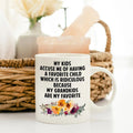 White ceramic mug with bold text and colorful floral bouquet near the bottom.